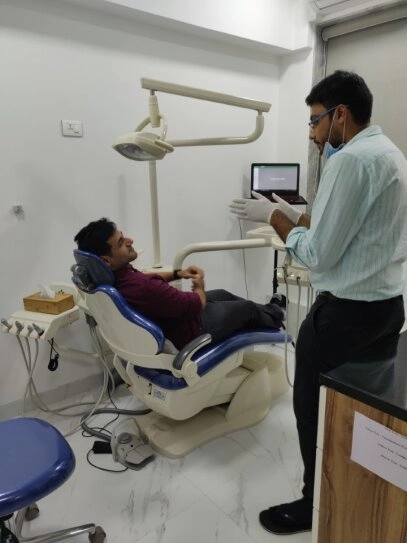 Orthodontist explaining bite correction treatment to a patient